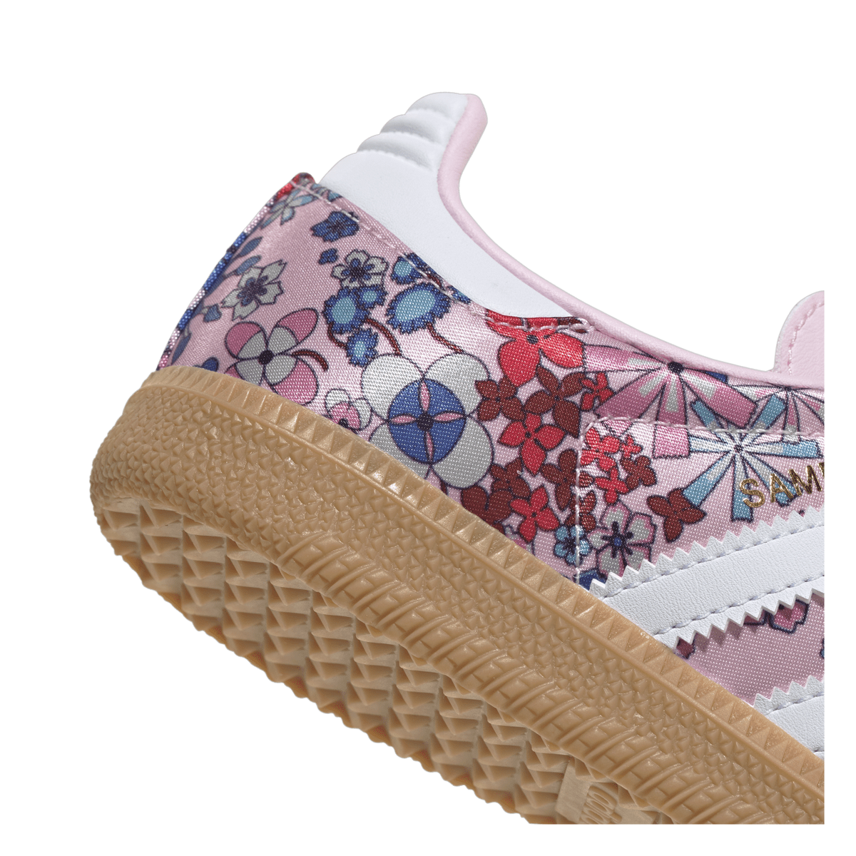 Close-up angled view of the heel and side of an Adidas Samba sneaker covered in a multicolor floral print with white leather panels and a gum sole.