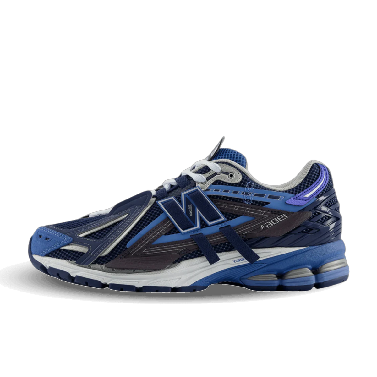 Side view of a navy and blue New Balance 1906A sneaker with purple heel accent and white midsole, toe pointing left.