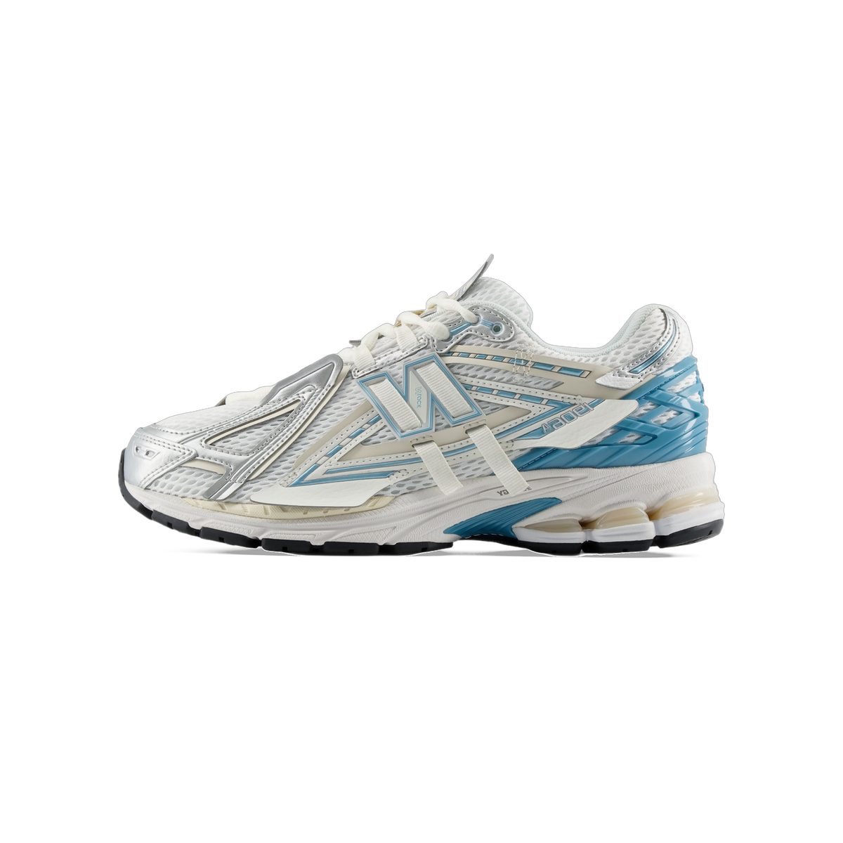 Side view of a white and silver New Balance 1906A sneaker with blue accents and a cream midsole with visible cushioning window.