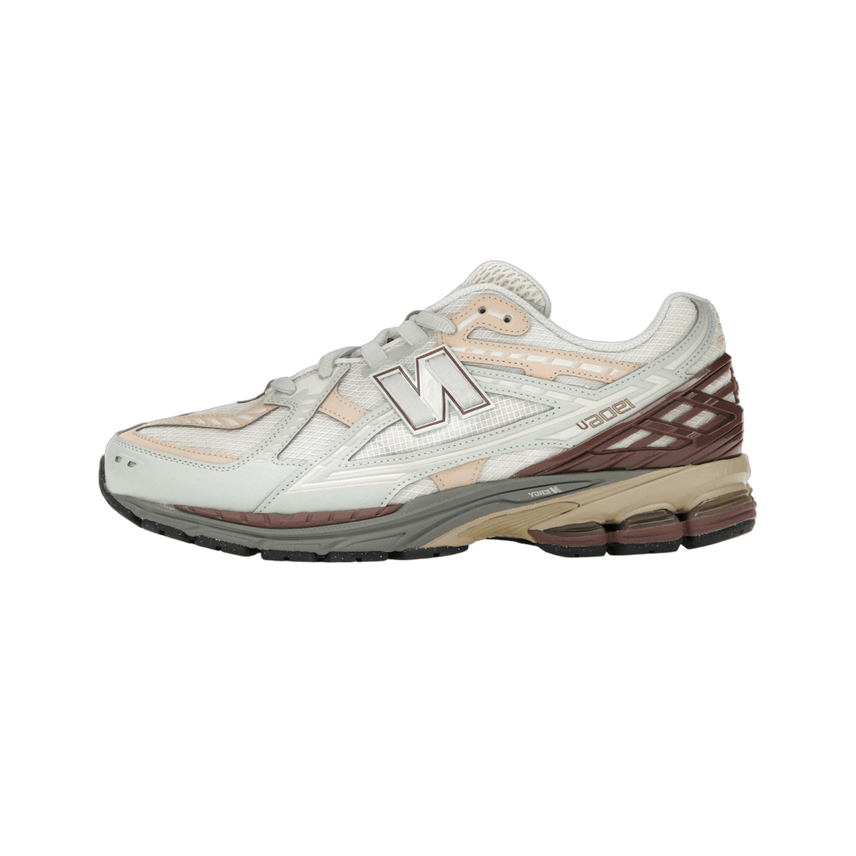 Left New Balance 1906D sneaker shown from the side with toe pointing left, featuring a grey and off-white mesh upper, brown heel overlay, tan and grey midsole, and a white N logo.