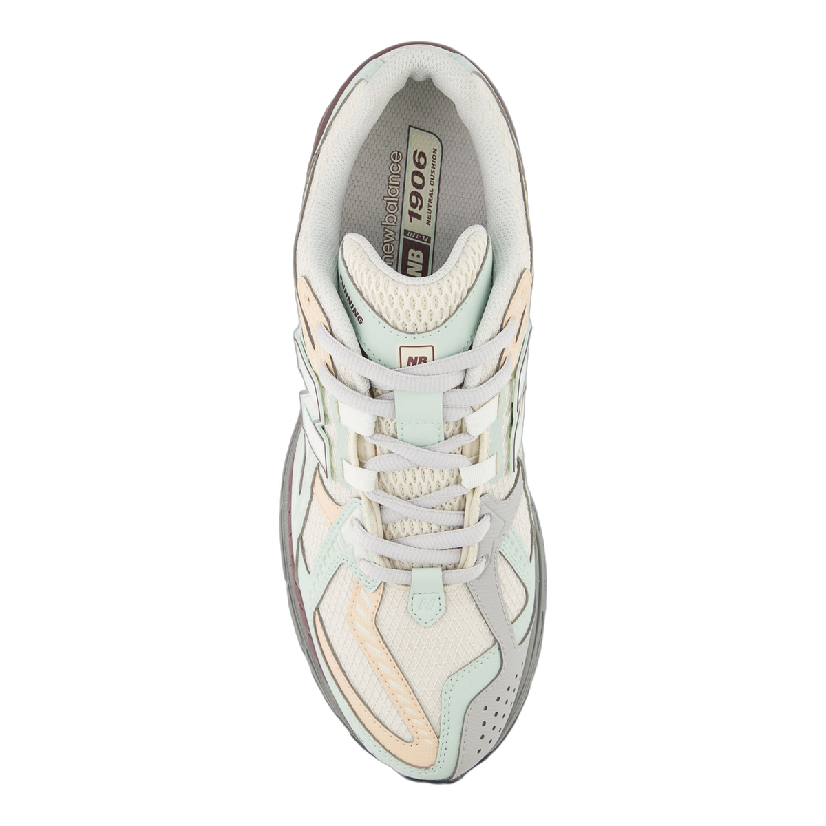 Top-down view of a New Balance 1906 sneaker in cream, mint green and peach tones with grey laces and a visible 1906 branded insole tongue tag.