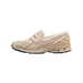 Side view of a beige New Balance 1906L sneaker with loafer-style strap, mesh overlays, and chunky layered midsole with black outsole.
