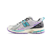 Side view of a white New Balance 1906R sneaker with purple accents, teal N logo, black heel panel, and teal-and-purple midsole, toe pointing left.