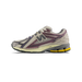 Side view of a New Balance 1906R sneaker in cream mesh with burgundy overlays, grey N logo, purple accents, and a yellow and grey midsole with black outsole.
