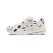 Side view of a white New Balance 1906R sneaker with black polka dot print, cream overlays, and a visible N logo badge, toe pointing left.