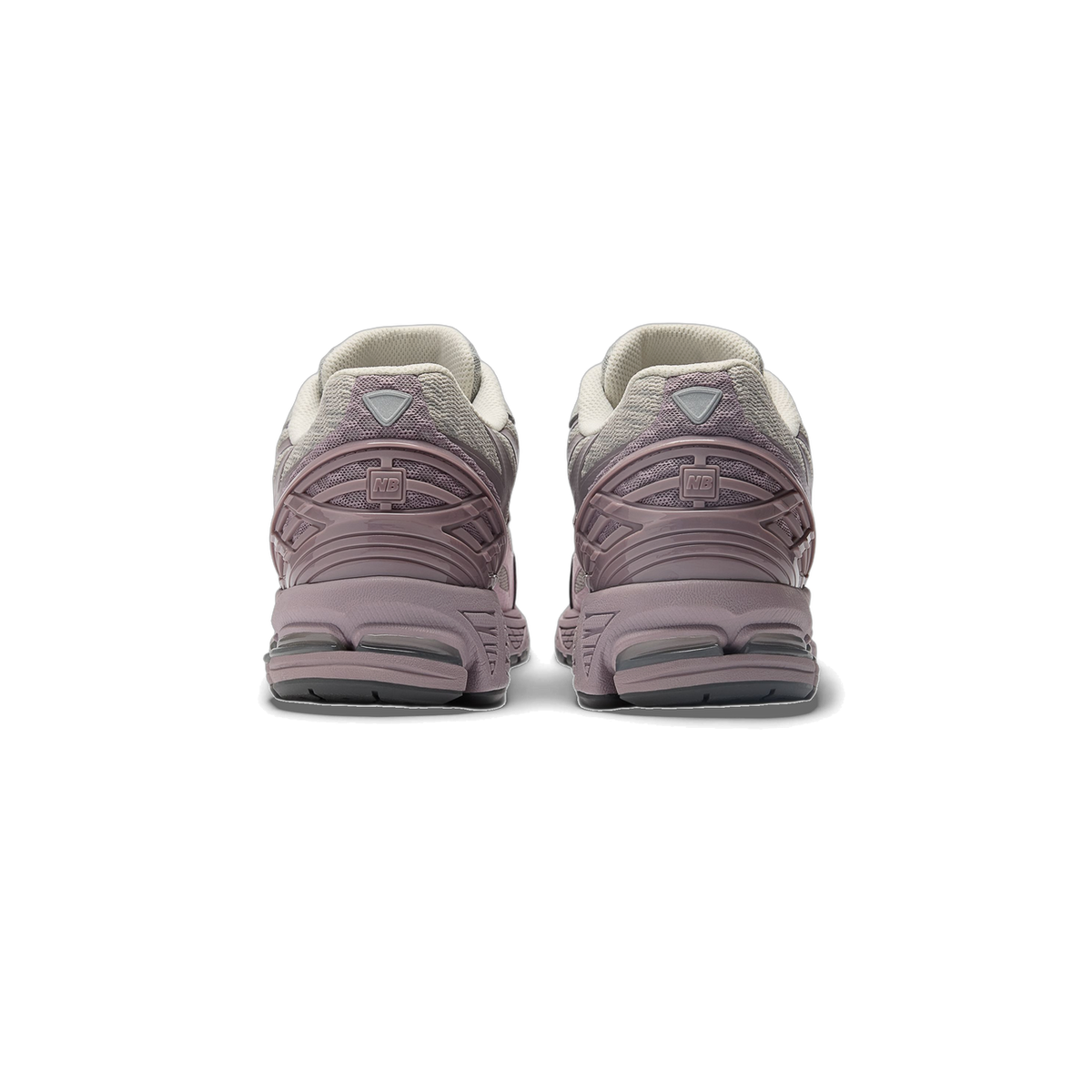 Rear view of a pair of New Balance 1906W sneakers in mauve and grey with NB logo on the heel tab