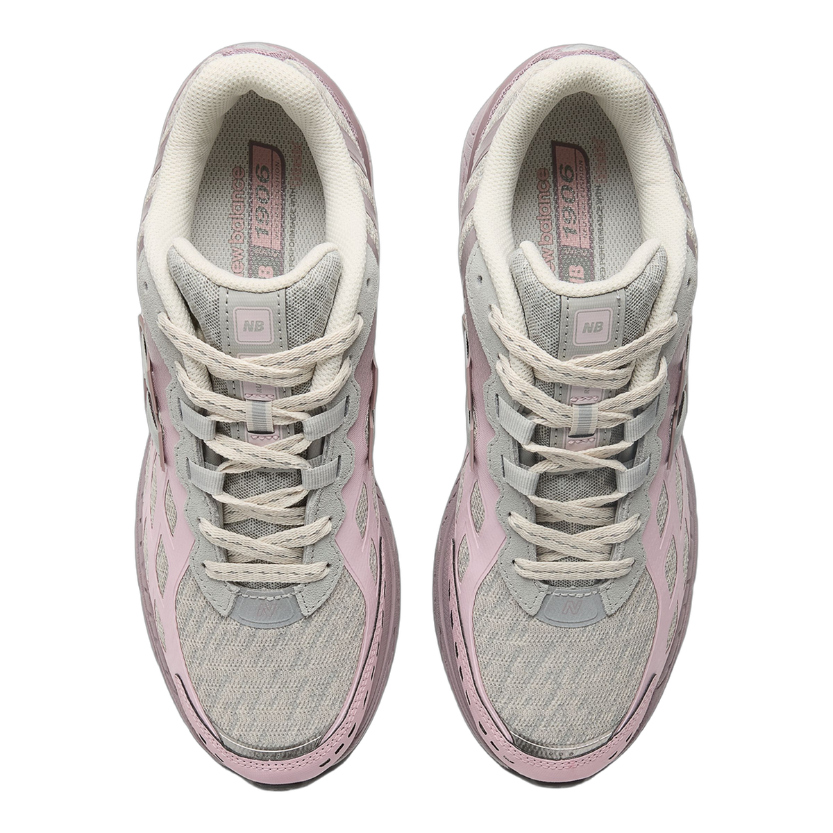 Top-down view of a pair of New Balance 1906 sneakers in grey and pink with cream laces and visible 'N' and 'NB' branding on the tongues
