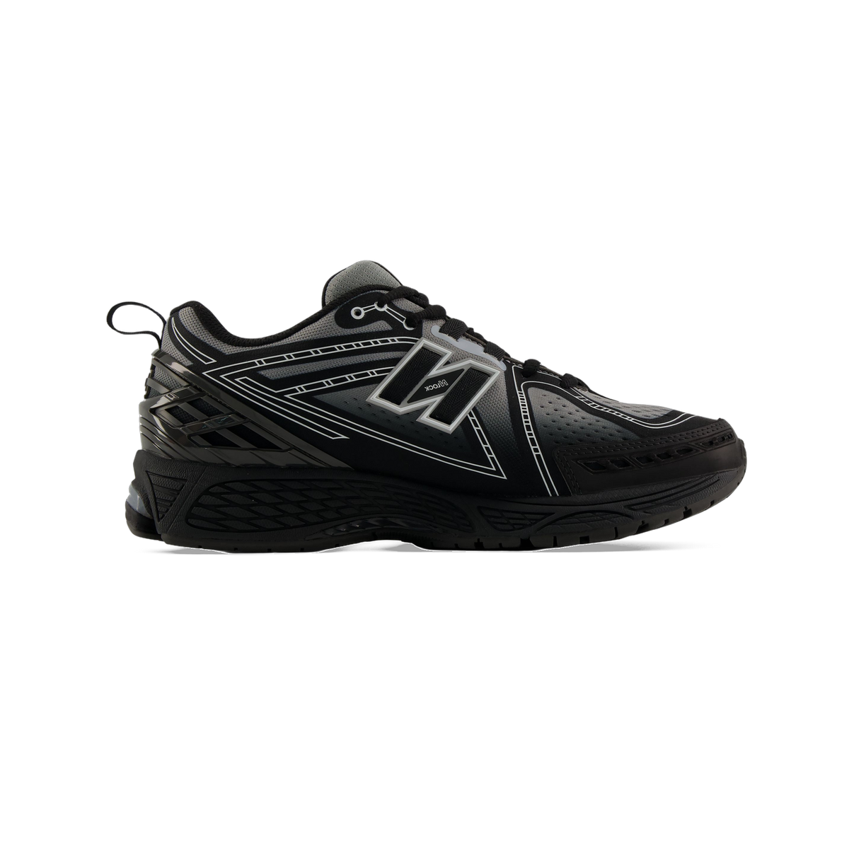 Side view of a black and grey New Balance 1906 sneaker with white outline graphics and a black N logo on the lateral side