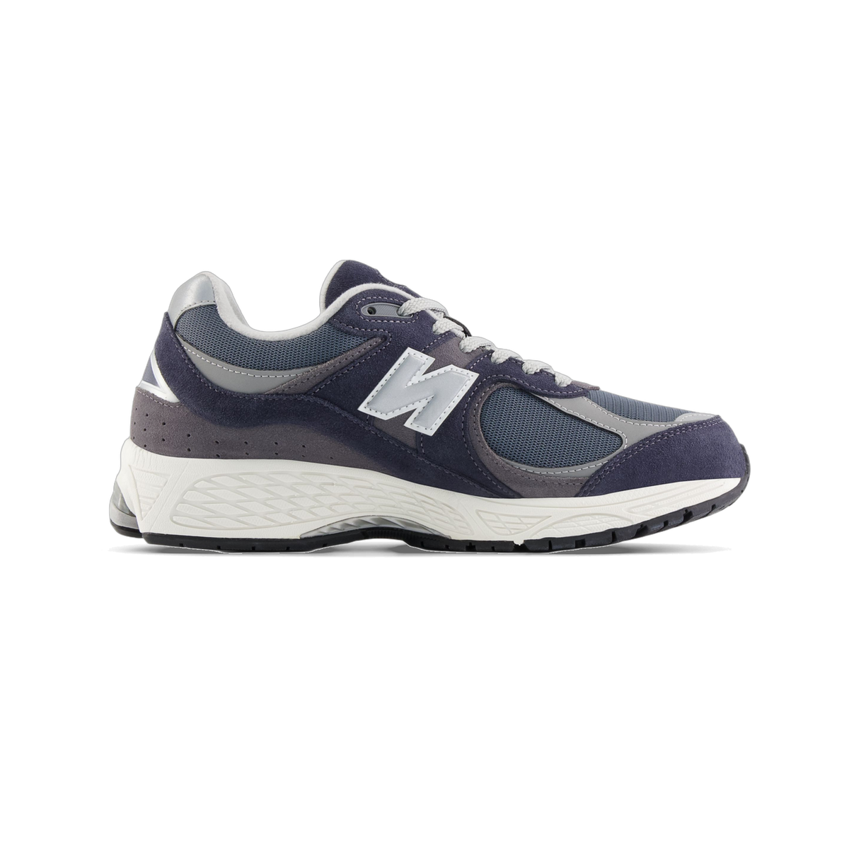 Side view of a navy and gray New Balance 2002R sneaker with a white N logo, toe pointing left, and white midsole with black outsole.