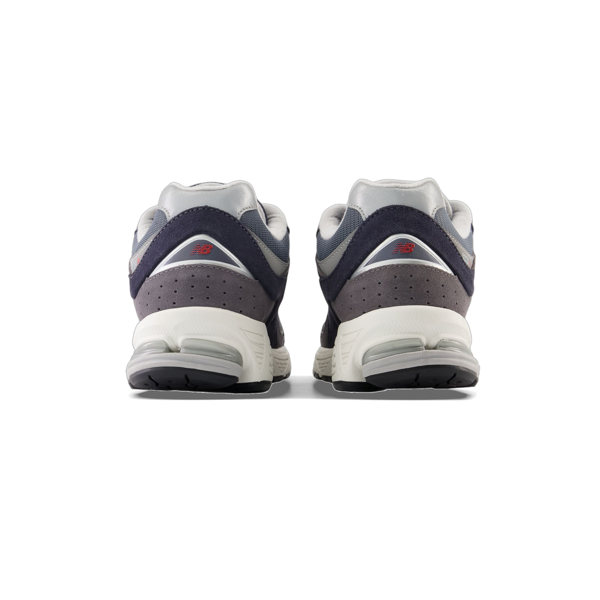 Rear view of a pair of New Balance 2002R sneakers in gray and navy with red New Balance logos on the heels and white midsoles