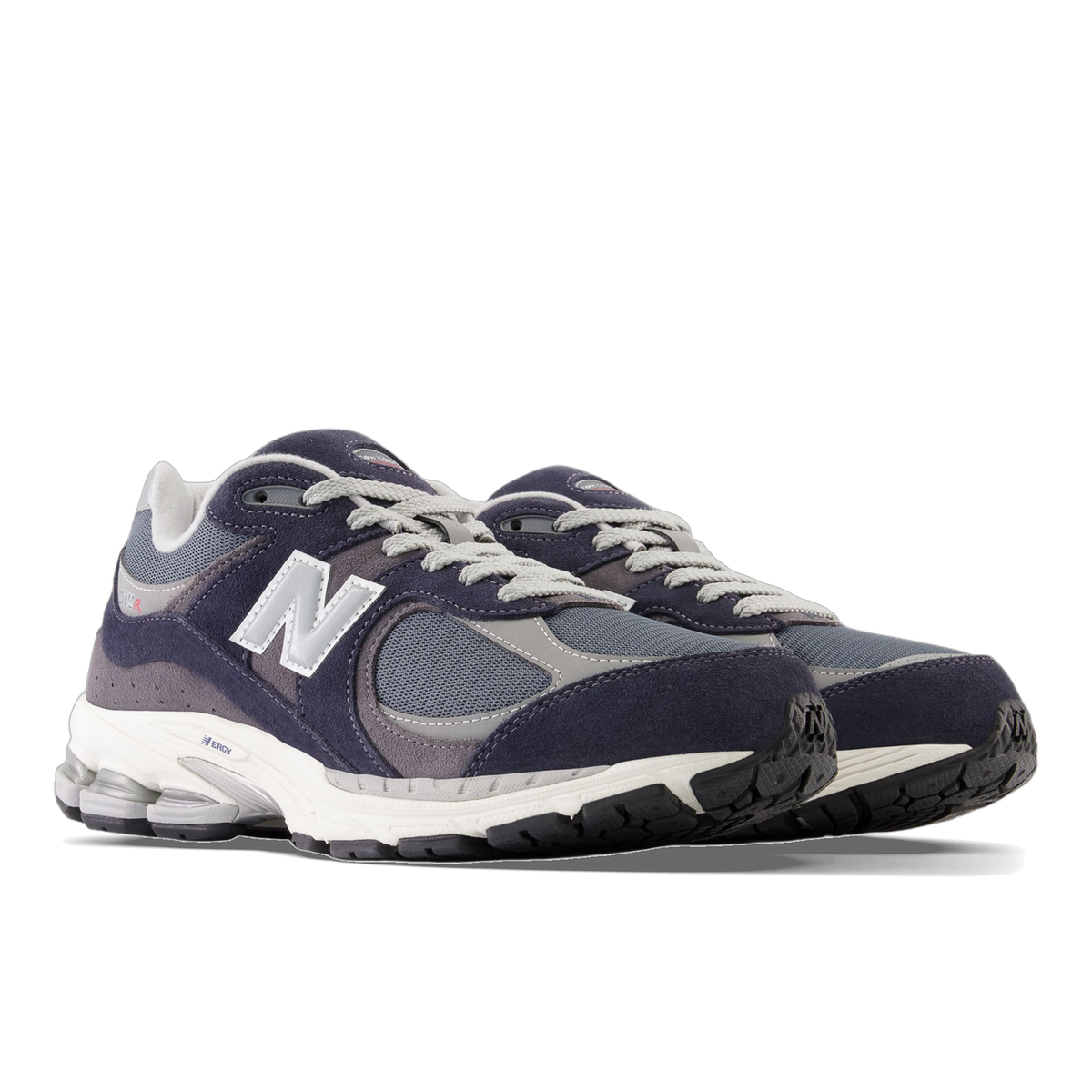 Pair of New Balance 2002R sneakers in navy and gray suede and mesh with white N logos, viewed from the front angled side showing a white and black chunky sole.