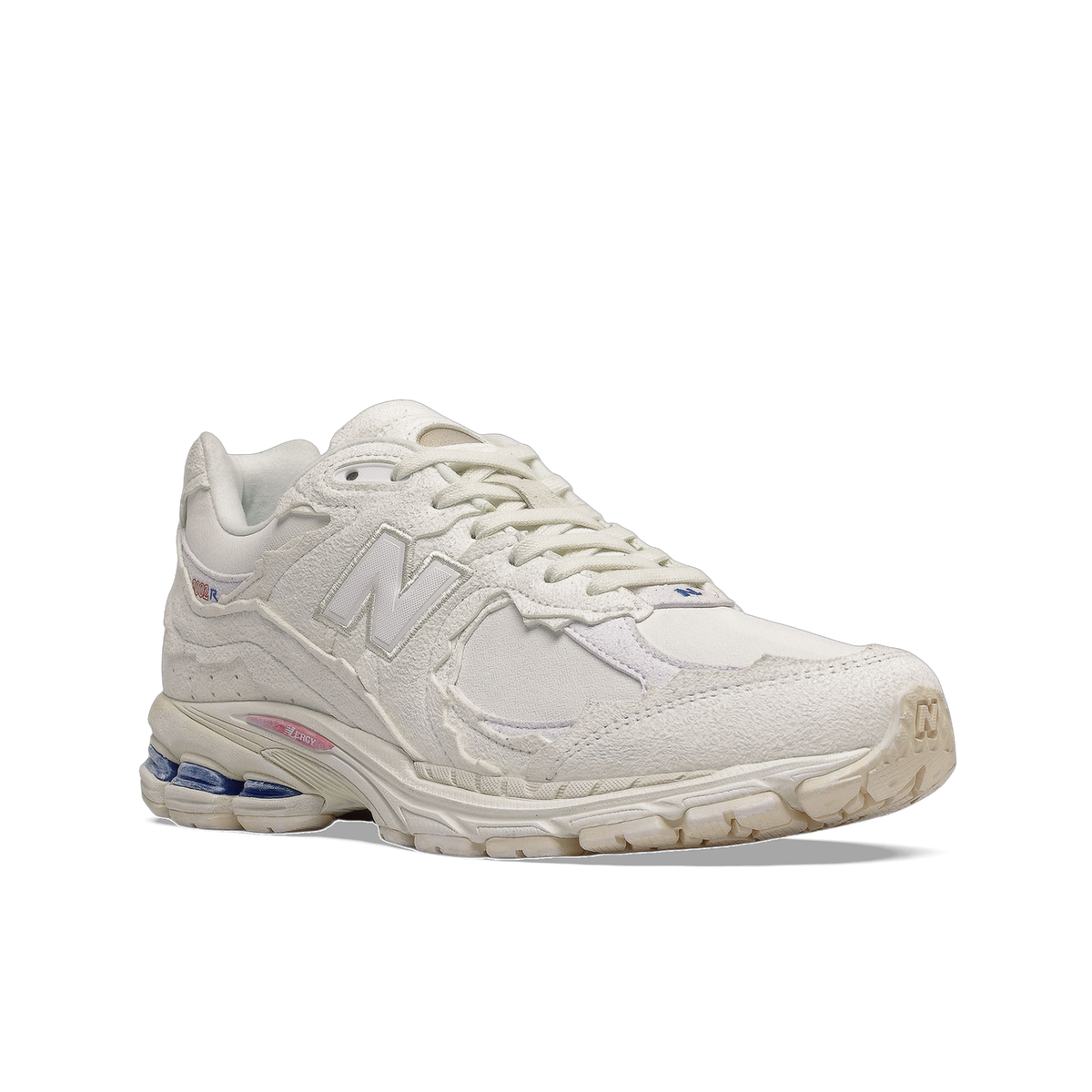 Angled front-side view of a white New Balance 2002R sneaker with a textured suede upper, embroidered N logo, and visible blue and pink accents on the midsole.