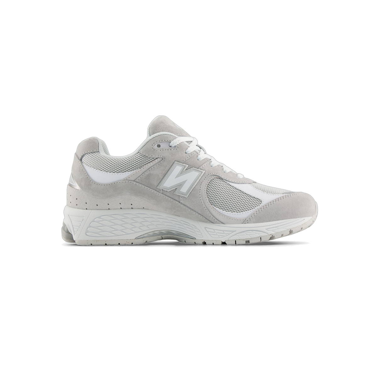 Side view of a grey New Balance 2002R sneaker with white mesh panels, white laces, and a white N logo on the toe pointing left, white midsole and outsole.