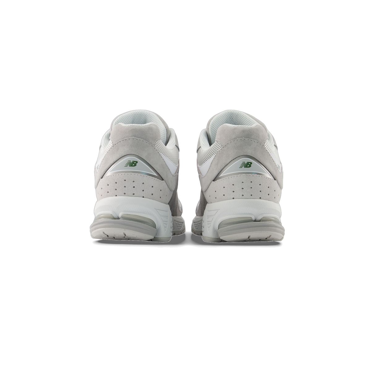 Rear view of a pair of gray and white New Balance 2002R sneakers showing the green NB logo on each heel.