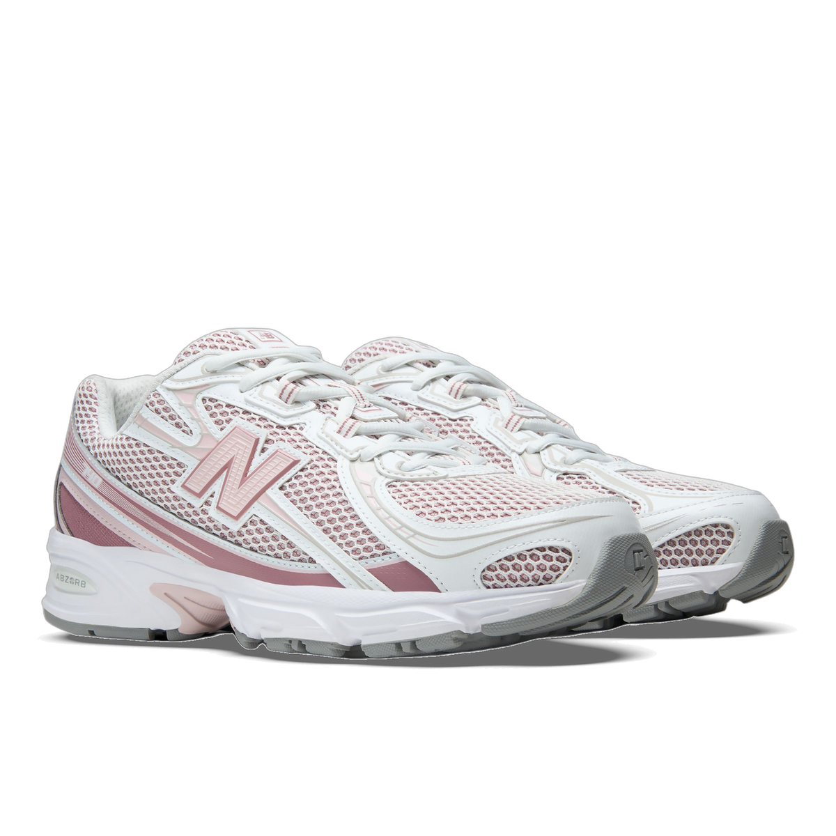 Pair of white New Balance 740 sneakers with pink and mauve mesh overlays, pink N logo, and white midsole with grey outsole, angled toward the left.