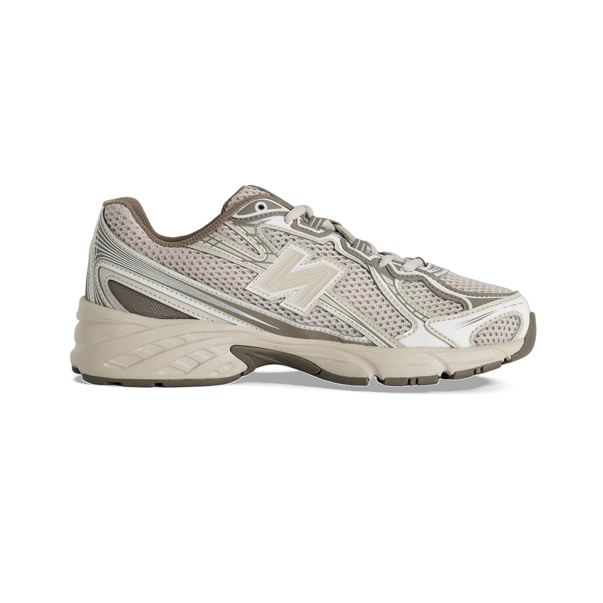 Lateral view of a beige New Balance 740 sneaker with mesh upper, silver N logo, and chunky tread sole.