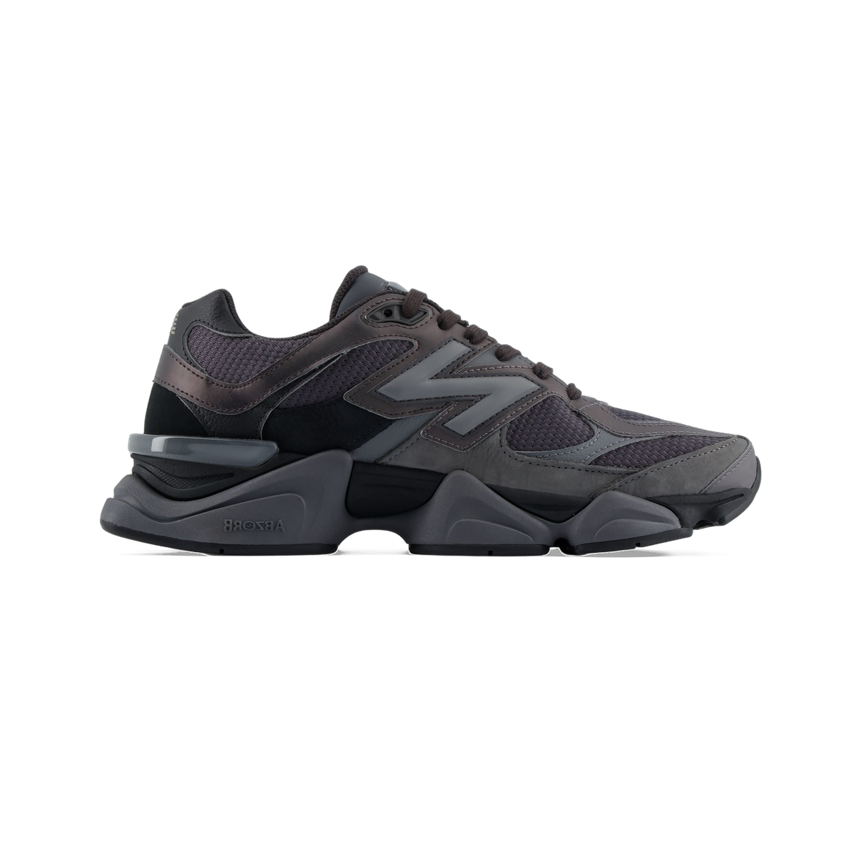 Lateral view of a black and gray New Balance 9060 sneaker with mesh upper, chunky layered midsole, and ABZORB branding on the sole.