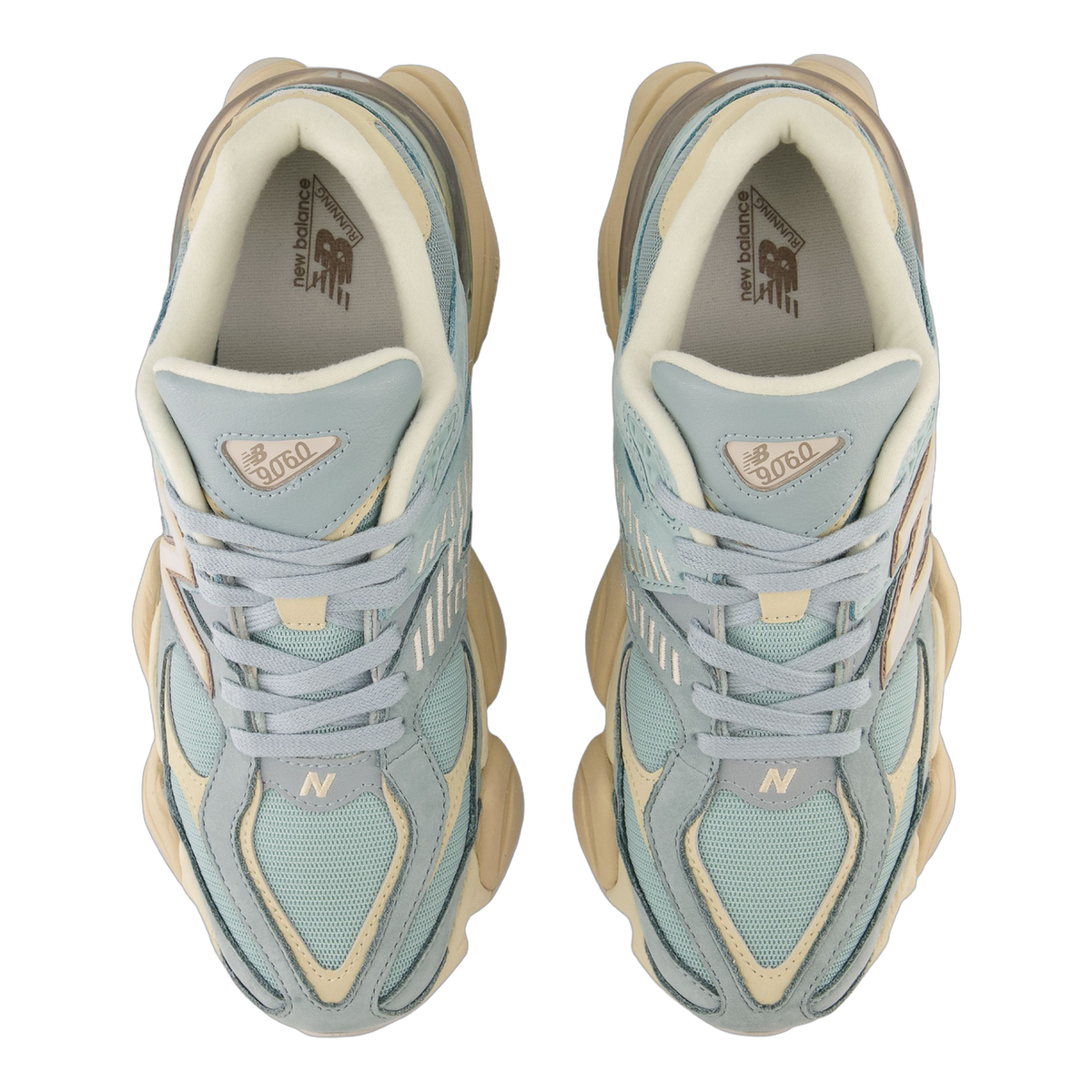 Top-down view of a pair of New Balance 9060 sneakers in light blue and cream with grey accents, showing the laces, tongue branding, and N logo on each shoe