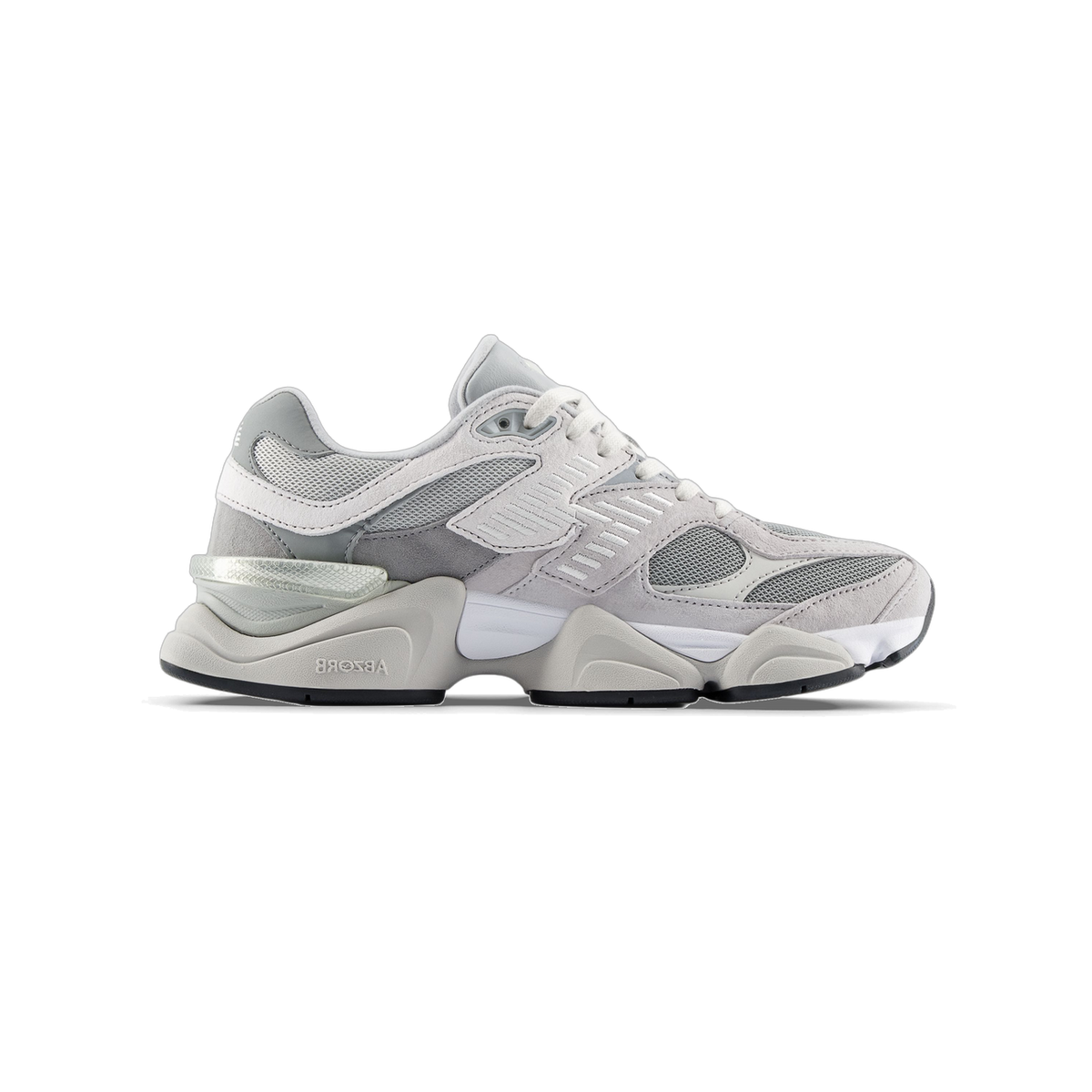 Side view of a gray and white New Balance 9060 sneaker with mesh panels, suede overlays, and a chunky layered sole featuring ABZORB cushioning text.