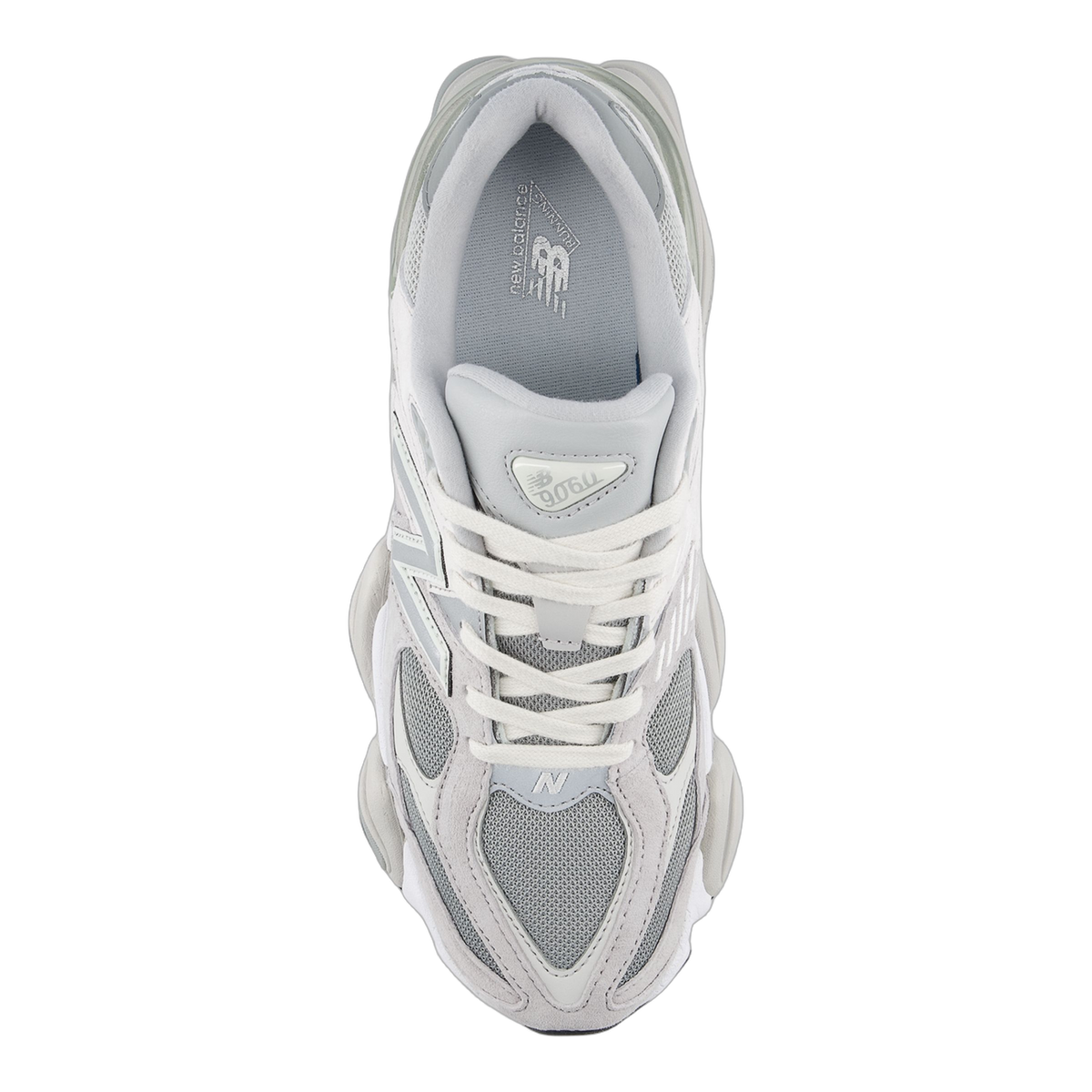 Top-down view of a gray and white New Balance 9060 sneaker showing the laces, tongue with branding, and N logo on the toe box.