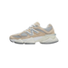 Side view of a beige New Balance 9060 sneaker with grey mesh panels, a silver N logo, white laces, and a chunky white midsole with black outsole, toe pointing left.
