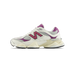 Side view of a white New Balance 9060 sneaker with pink N logo, purple heel and overlay accents, and a cream chunky sole, toe pointing left.
