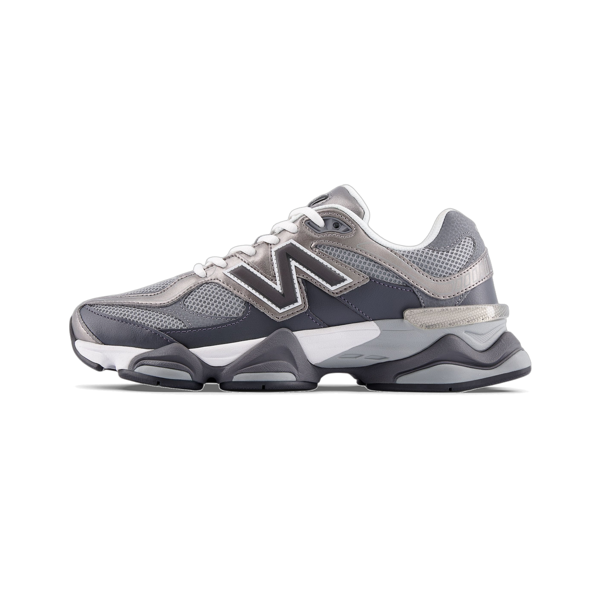 Left New Balance 9060 sneaker in gray and silver tones shown from the side with toe pointing left, featuring a large N logo and chunky layered sole.