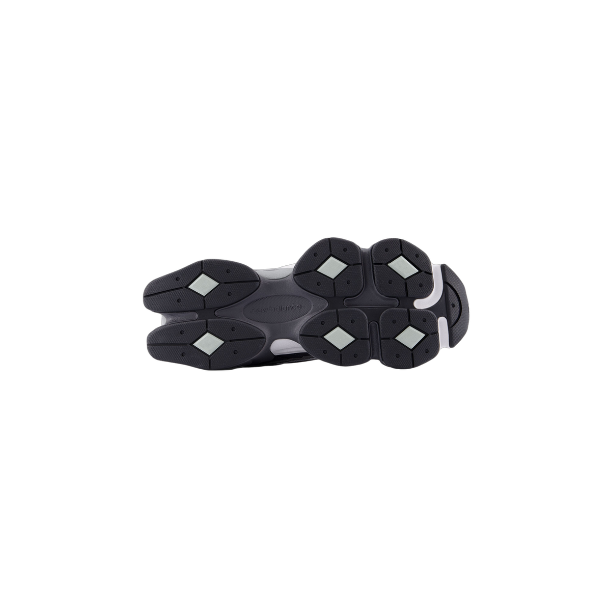 Bottom view of a New Balance 9060 sneaker showing the dark gray outsole with diamond-shaped lugs and New Balance branding on the midsole