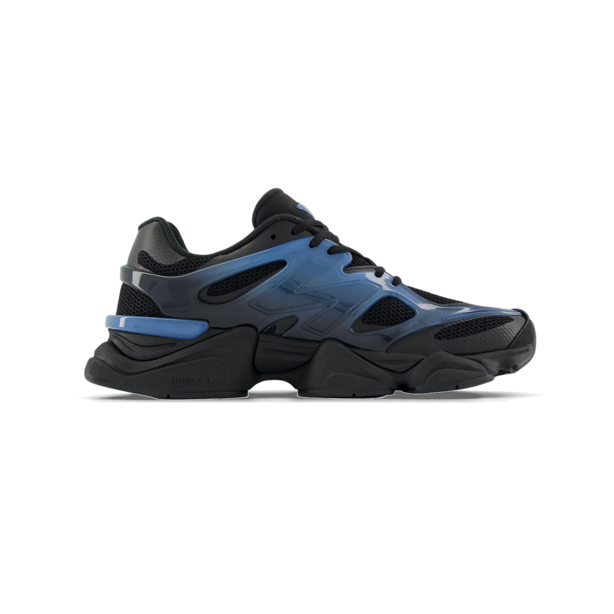 Side view of a black New Balance 9060 sneaker with a blue gradient overlay featuring the N logo, mesh panels, and a chunky black midsole