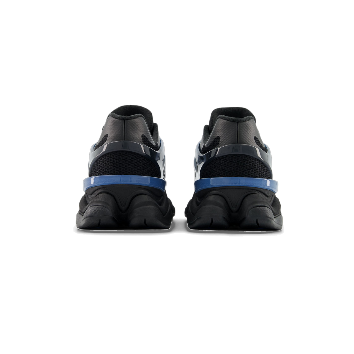 Rear view of a pair of black New Balance 9060 sneakers with blue heel accents and a chunky ridged black midsole.