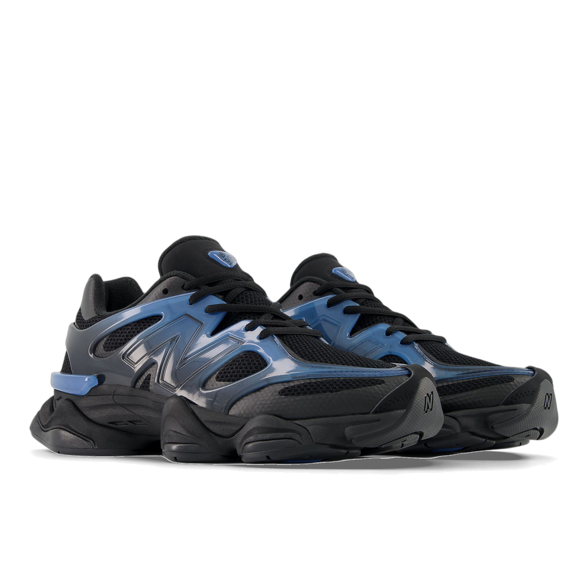 Pair of New Balance 9060 sneakers in black mesh with a translucent blue-gradient N logo panel and black laces, angled toward the left.