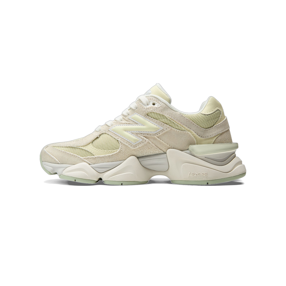 Left New Balance 9060 sneaker in cream and pale green suede and mesh, shown from the outside with a chunky sole and pastel green heel accent, toe pointing left.
