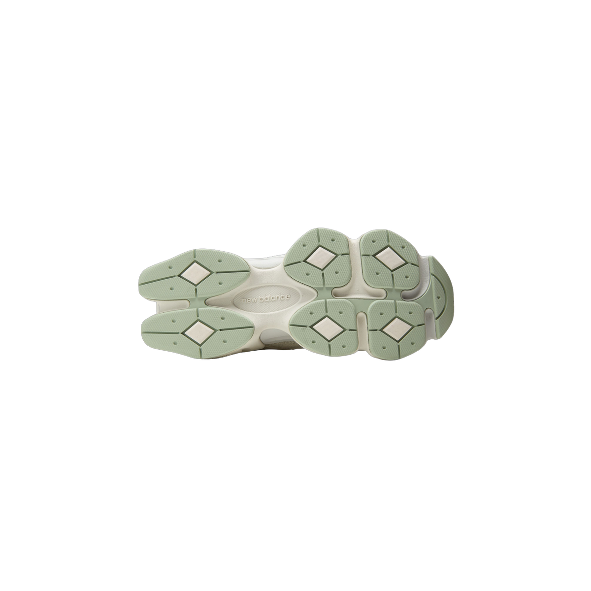 Bottom view of a New Balance 9060 sneaker outsole showing a sage green and cream diamond-patterned tread with the New Balance logo embossed in the center.