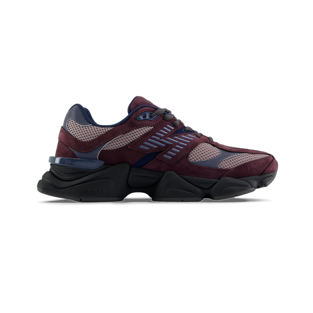 Side view of a single New Balance 9060 sneaker in plum and mauve suede with navy mesh panels and a chunky black midsole, toe pointing left.