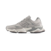 Lateral view of a gray New Balance 9060 sneaker with mesh panels, chunky white and gray midsole, and a black outsole.