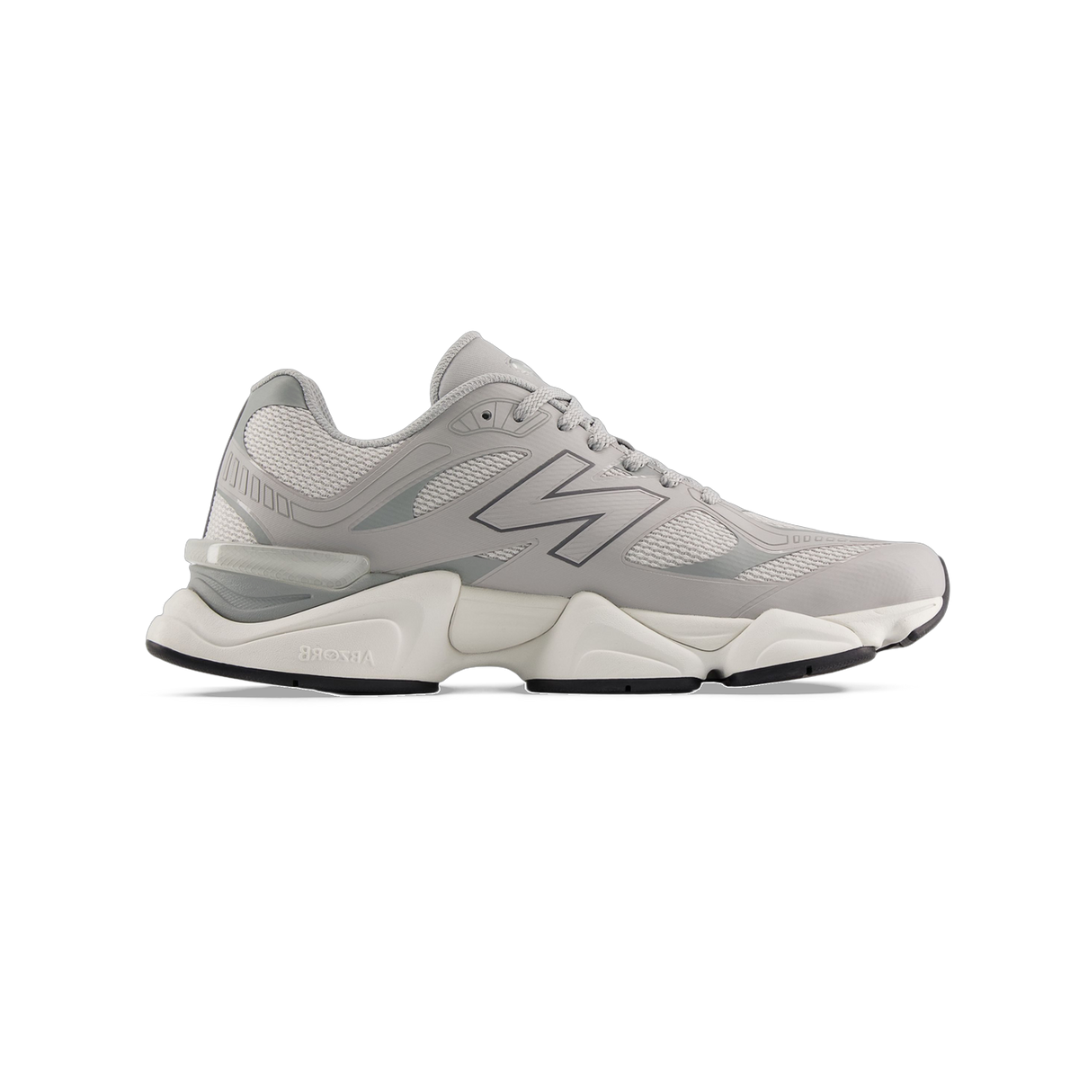 Side view of a gray New Balance 9060 sneaker with mesh panels, dark gray N logo, and a thick off-white ABZORB midsole with black outsole.