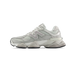 Side view of a light gray New Balance 9060 sneaker with mesh panels, metallic silver accents, and a chunky white midsole.