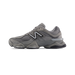 Side view of a grey New Balance 9060 sneaker with a white N logo, mesh paneling, and a chunky sole with visible gel heel insert.