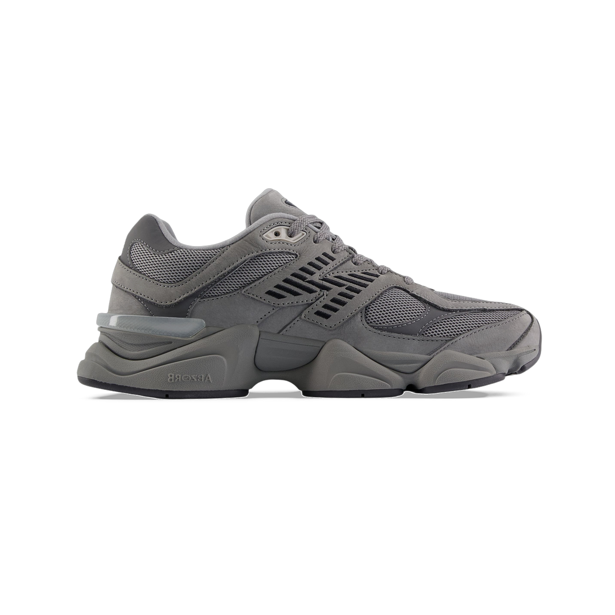 Side view of a gray New Balance 9060 sneaker with mesh panels, dark stitched overlays, chunky midsole, and ABZORB branding on the outsole.