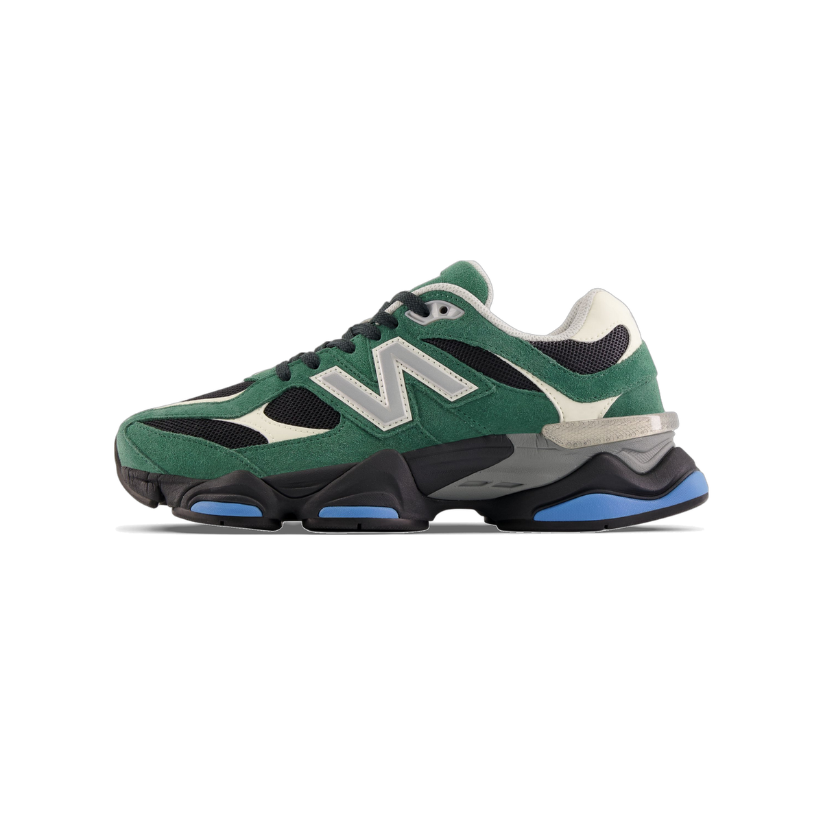 Side view of a green suede New Balance 9060 sneaker with black mesh panels, grey N logo, cream accents, and a chunky black midsole with blue outsole details.