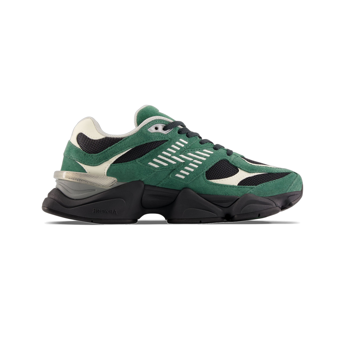 Side view of a green suede New Balance 9060 sneaker with black mesh panels, white stitched overlays, cream accents, and a chunky black midsole with a translucent heel insert.