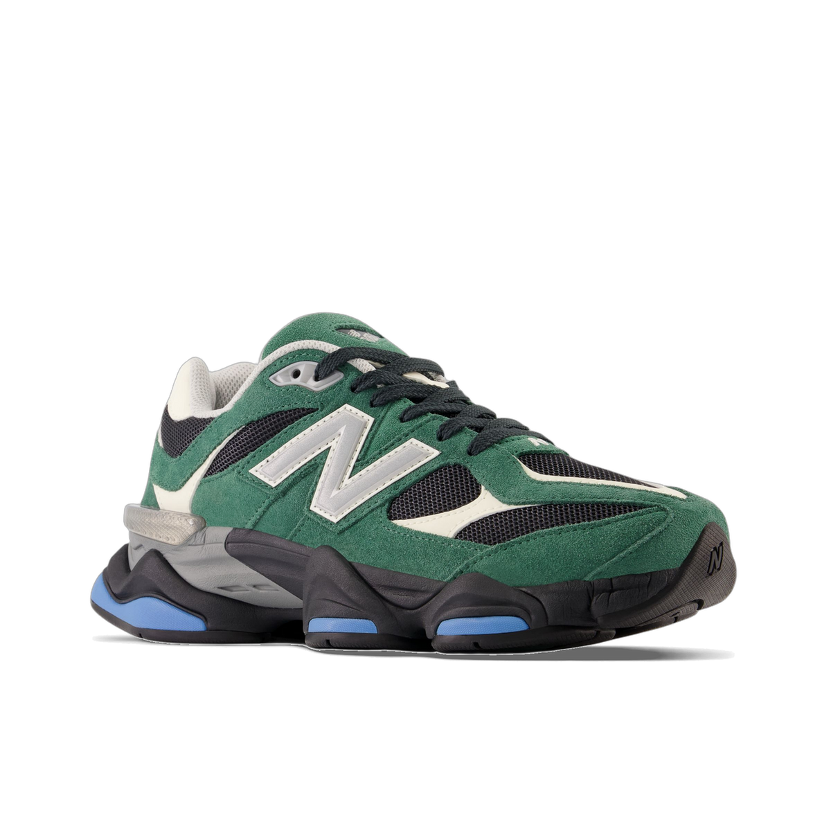 Angled side view of a green suede New Balance 9060 sneaker with black mesh panels, silver N logo, cream accents, and a chunky black and blue outsole, toe pointing left.