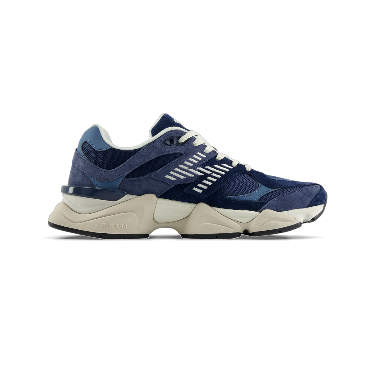 Side view of a navy blue New Balance 9060 sneaker with suede panels, white lace detailing, and a thick off-white Abzorb cushioned sole, toe pointing left