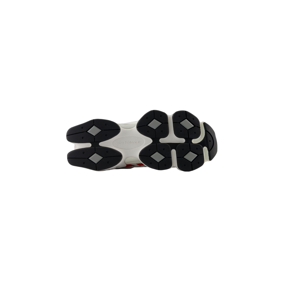 Bottom view of a white New Balance 9060 sneaker showing the black lug outsole with diamond-shaped tread and New Balance logo embossed in the center