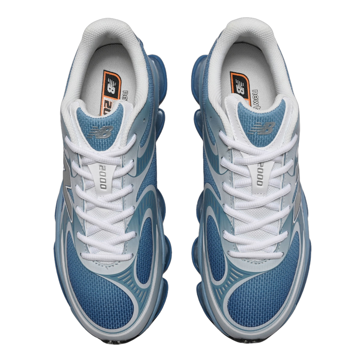 Top-down view of a pair of blue and white New Balance 2000 sneakers with white laces and silver N logos on the sides.