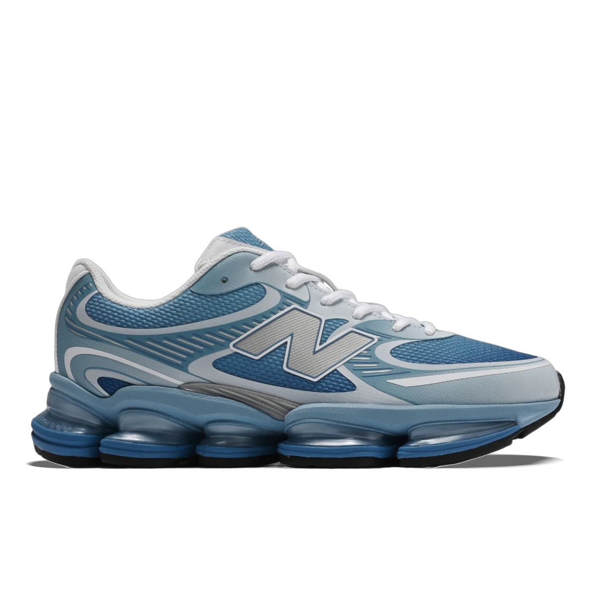 Side view of a blue and white New Balance Abzorb 2000 sneaker with a silver N logo and segmented blue Abzorb midsole, toe pointing left.