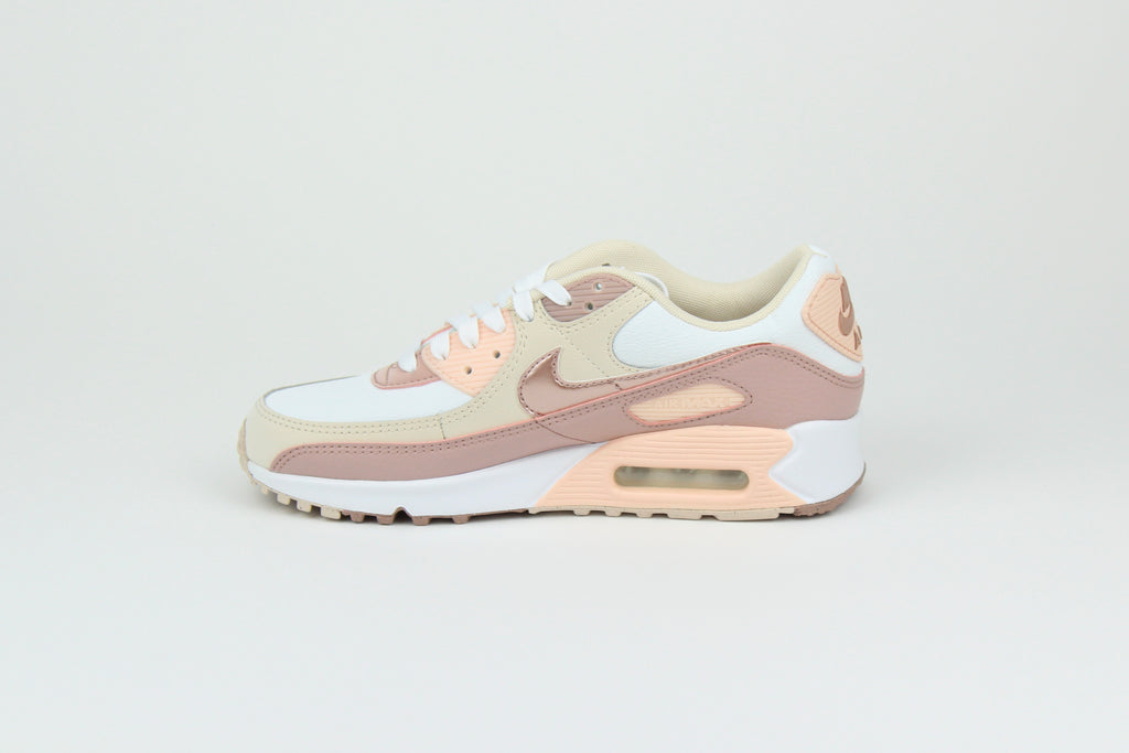 Eco‑friendly Air Max 90 in “Washed Coral” & “Particle Pink” with visible Air cushioning. Limited July 2025 release. Shop now at The Attic!