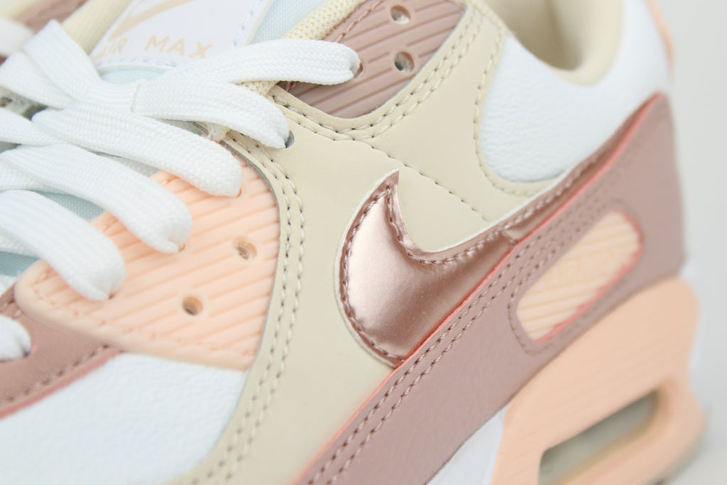 Eco‑friendly Air Max 90 in “Washed Coral” & “Particle Pink” with visible Air cushioning. Limited July 2025 release. Shop now at The Attic!
