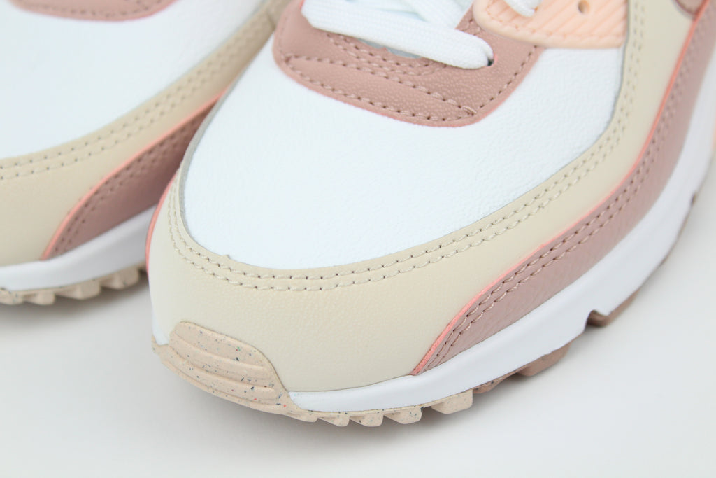 Eco‑friendly Air Max 90 in “Washed Coral” & “Particle Pink” with visible Air cushioning. Limited July 2025 release. Shop now at The Attic!