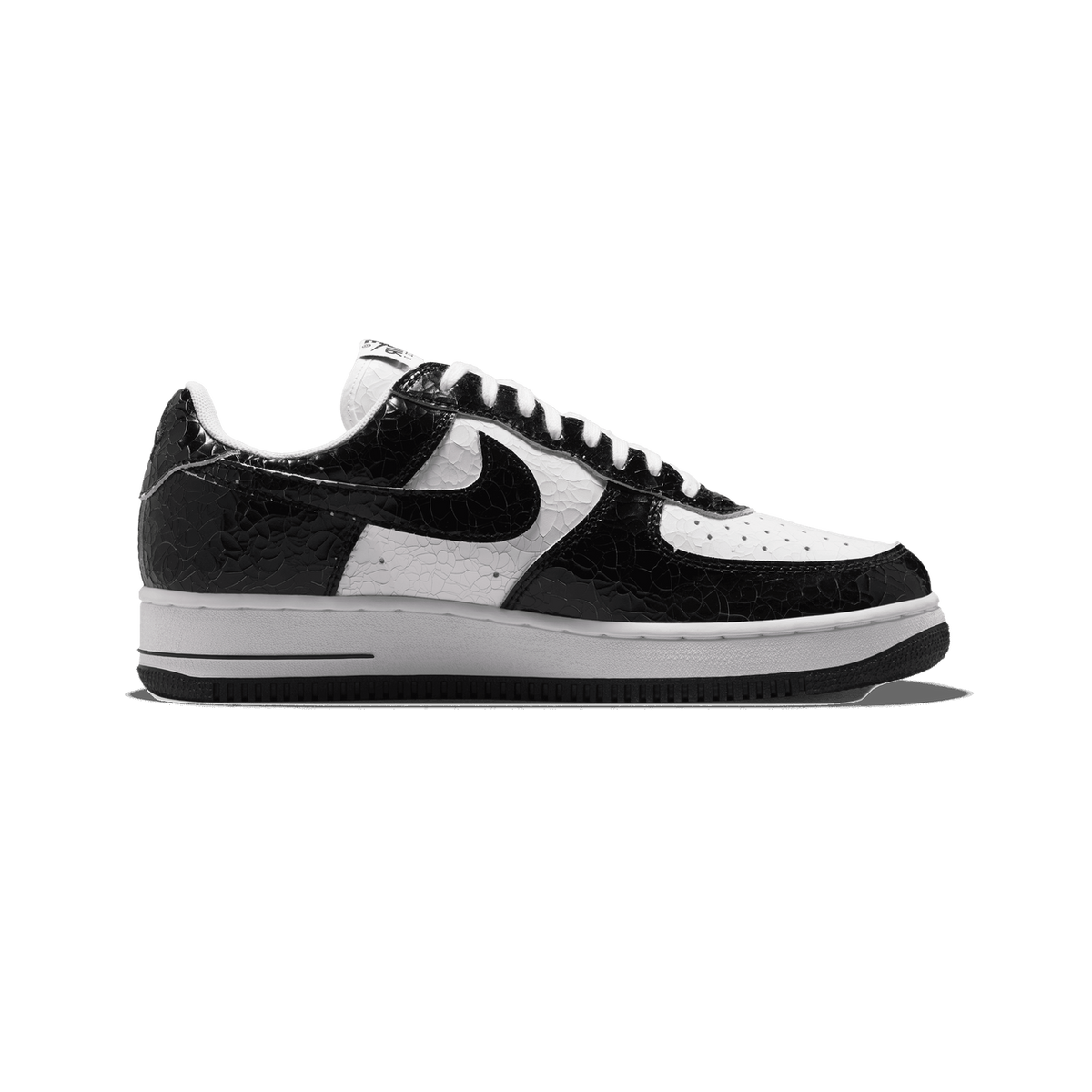 Left Nike Air Force 1 Low sneaker in black and white cracked leather pattern with black swoosh, toe pointing left, white midsole and black outsole.